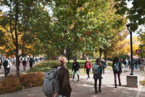 Students walking across campus on a fall day