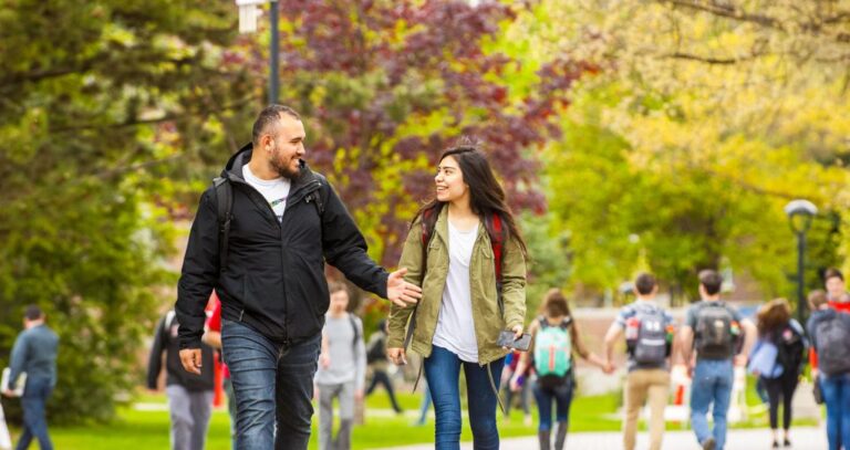 Students walking across campus talking