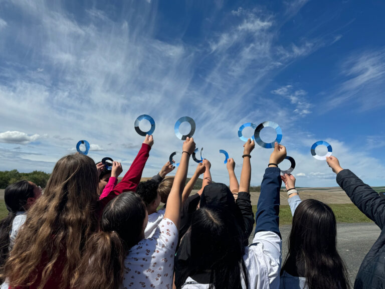 People holding up art to the sky