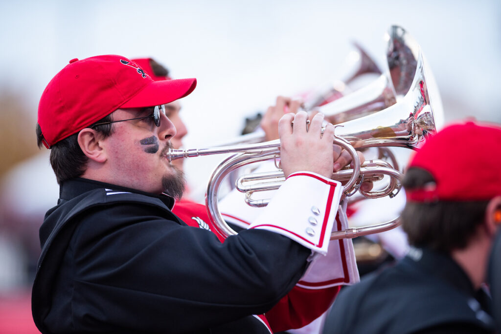 EWU Marching Band members play trumpets at a football game. 