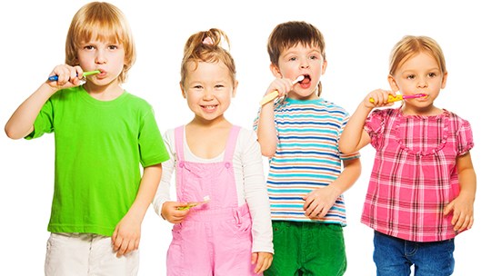 Group of children brushing their teeth
