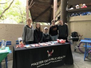 Group photo of students at the MPH info table