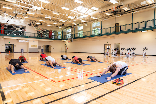 A yoga instructor leads a class