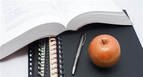 Textbook with notebooks and pen