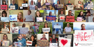 Group photo of people holding Go Eags signs