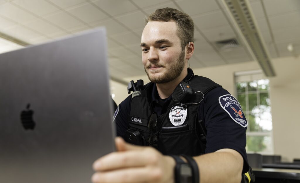 Law enforcement officer taking online classes.