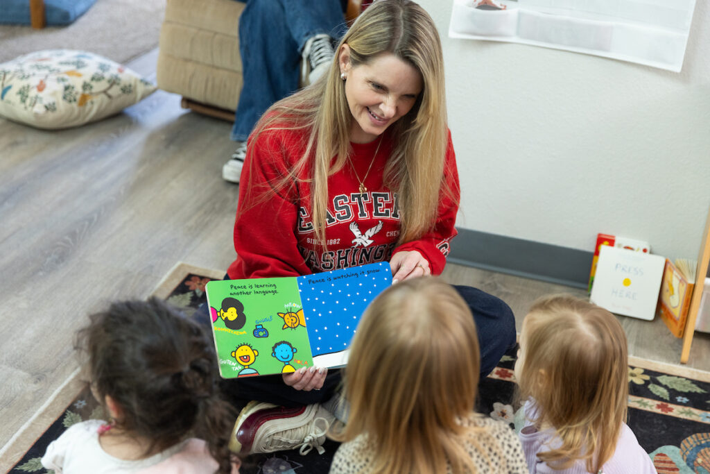 A teacher reads a book to children at a local preschool
