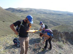 Students examine rocks in the field 