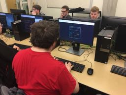 Students type at computers