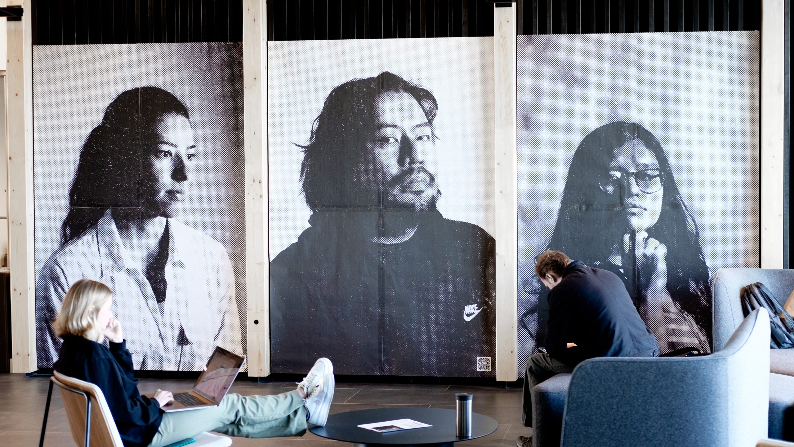 students in study space - portraits on the walls