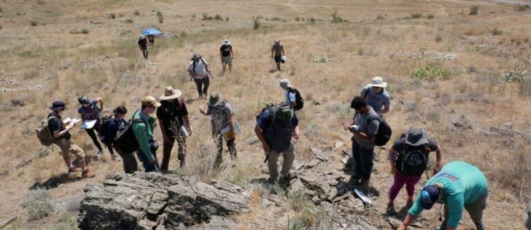 Geoscience students out on the saltese area studying rock formations