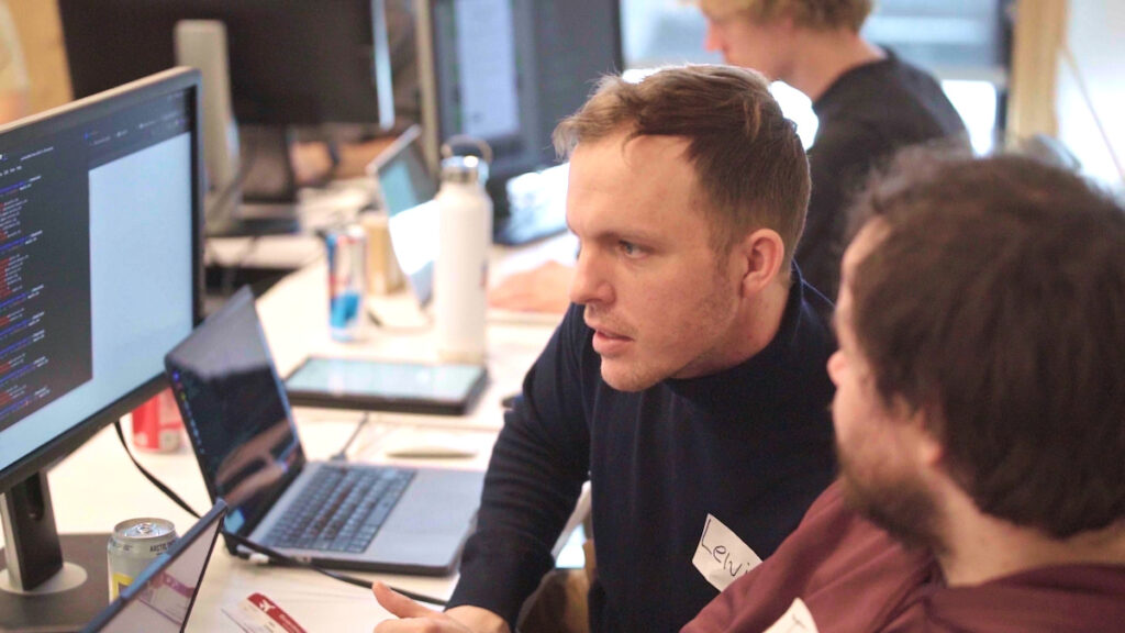 Two EWU computer science cyber students work on a group project in class.