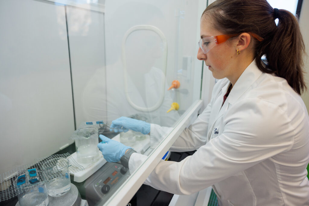 Girl working in a lab mixing chemicals