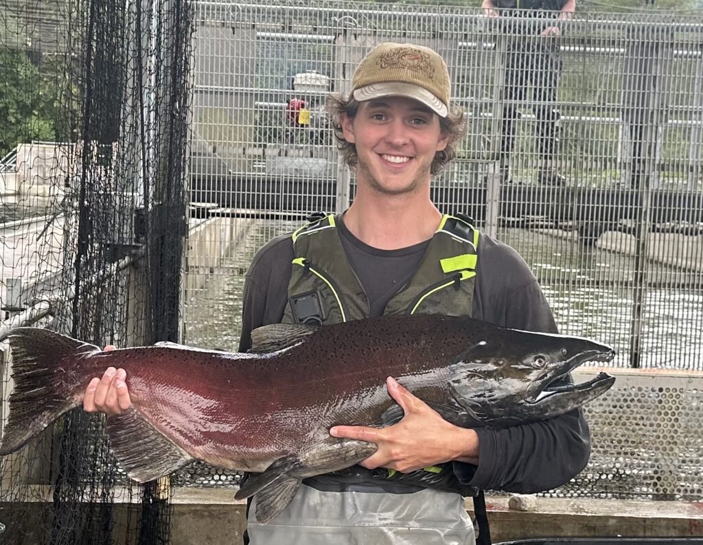 Student Sam Caruso holds a Westslope Cutthroat Trout 