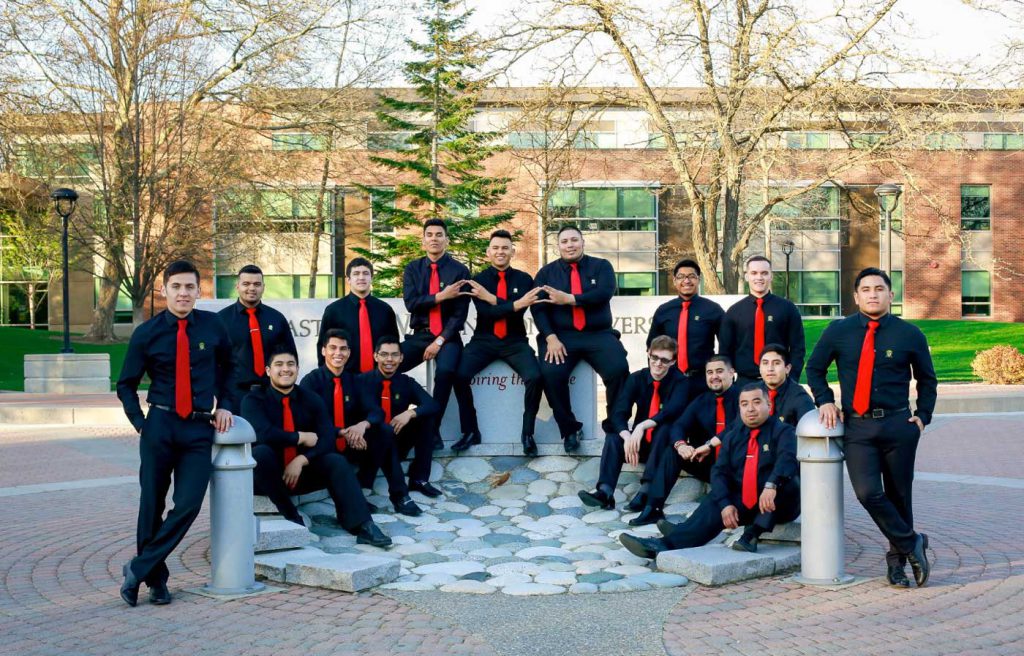 Photo: Men posing outside in black dress shirts and red ties