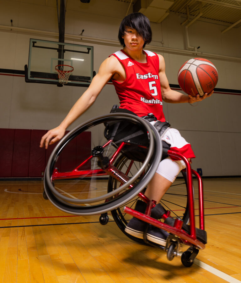 Adaptive Athletic student in his wheelchair with basketball.