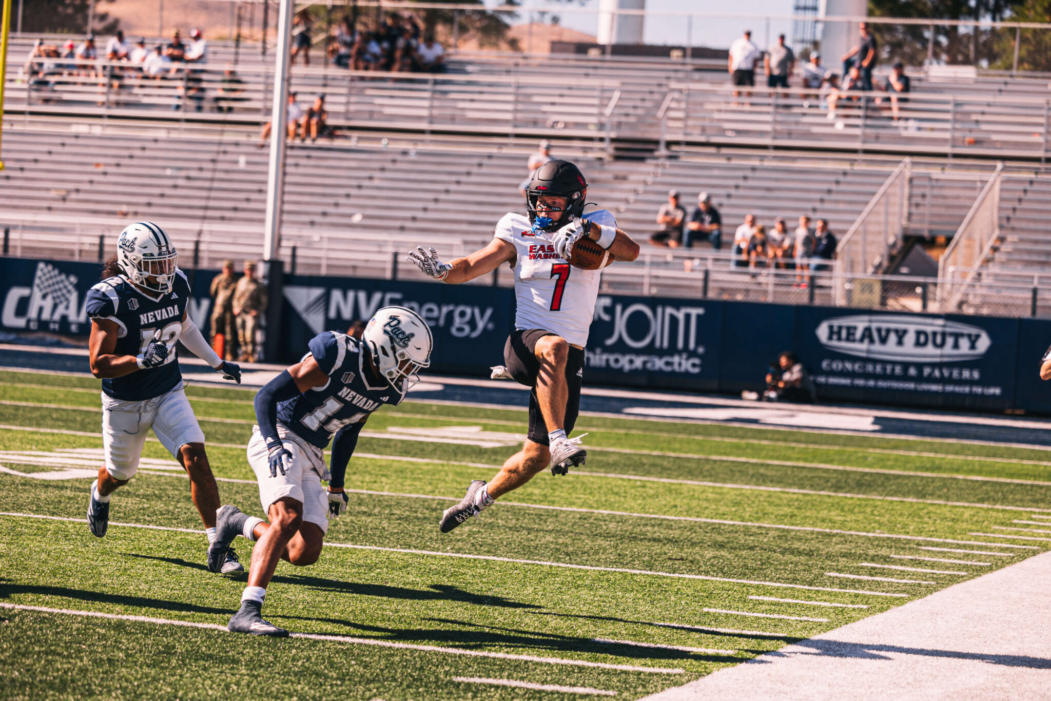 Efton dodging a tackle on the football field.