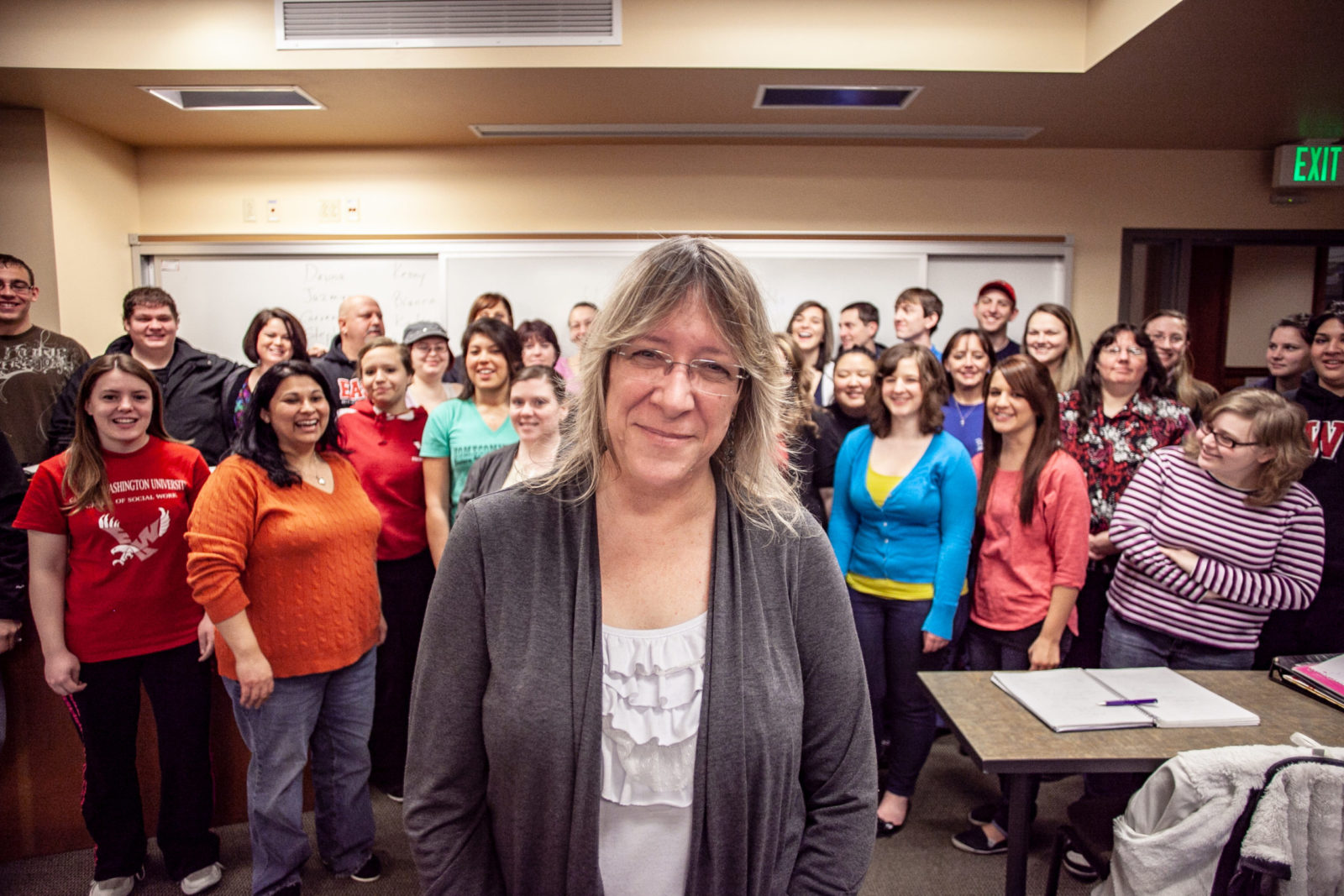 Lu Brown smiles with a classroom full of her students in the background