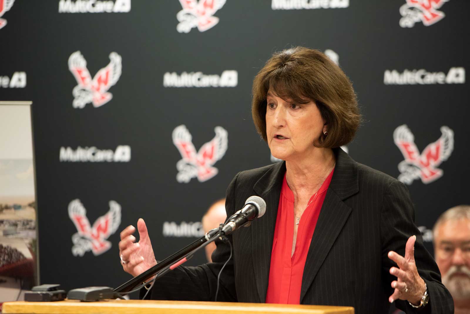 Lynn Hickey speaks at a podium during a press conference