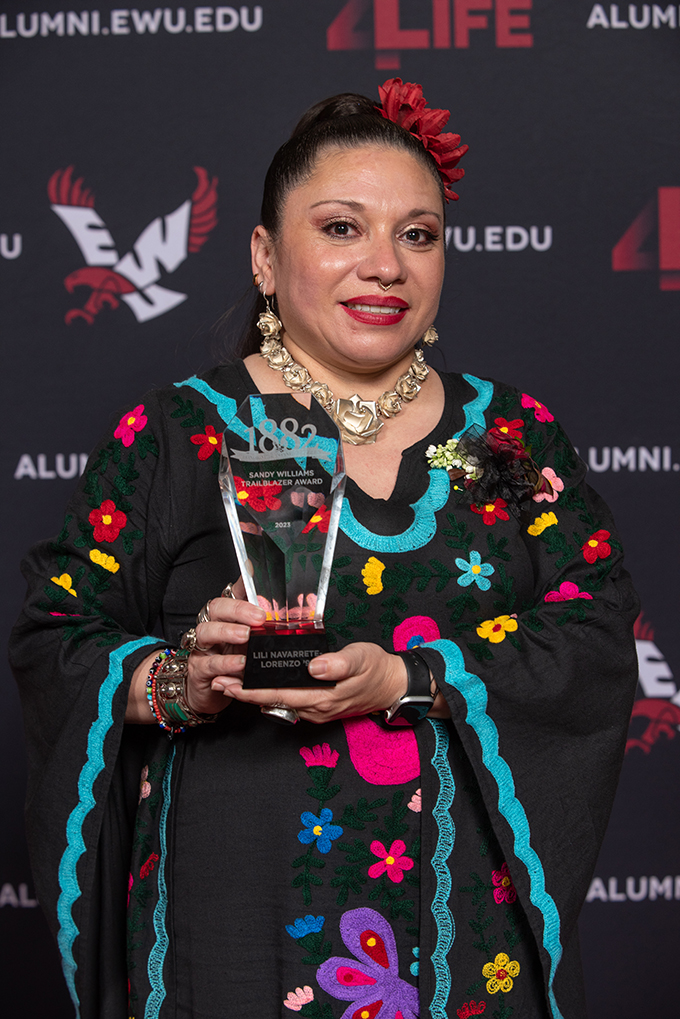 Lili Navarrete holding her award.