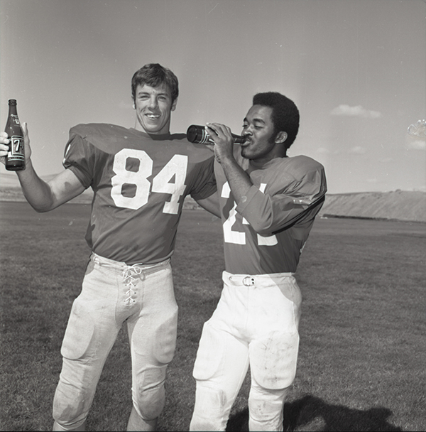 Two football players drinking seven-up