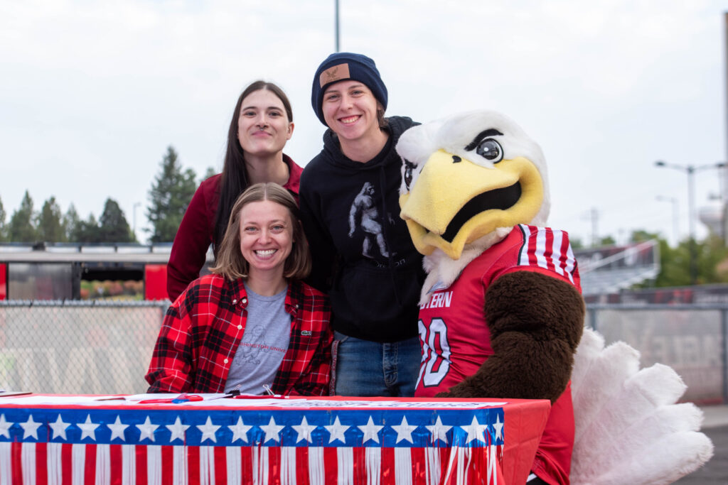 A group of EWU students pose with Swoop at Roos Field.