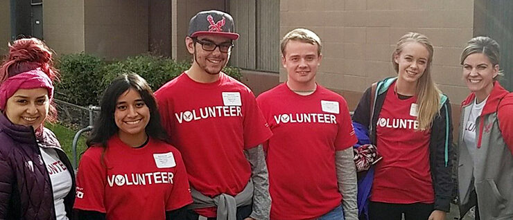 Community service students wearing volunteer shirts