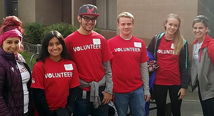 Community service students wearing volunteer shirts