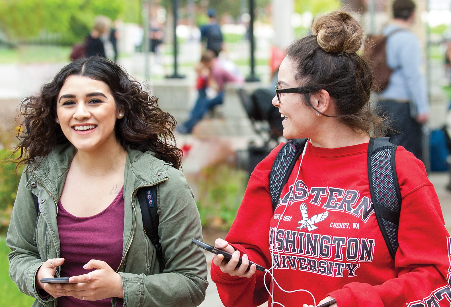 Photo: Two students laughing with phones
