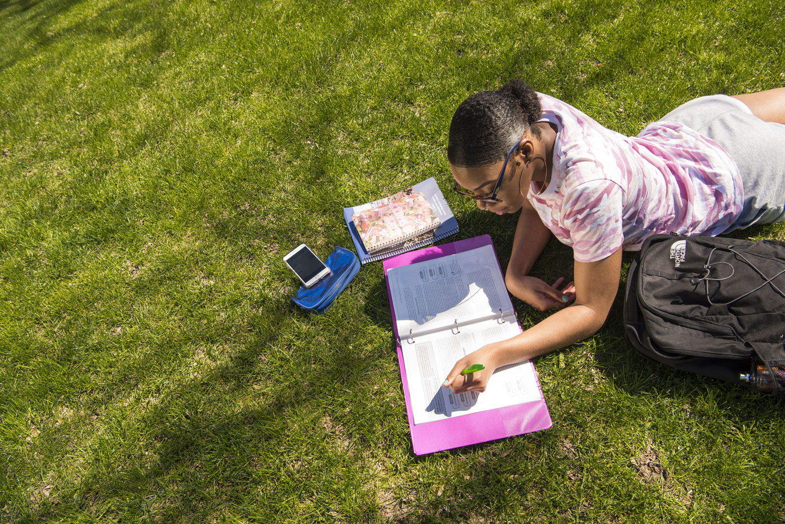 Woman studying in the grass