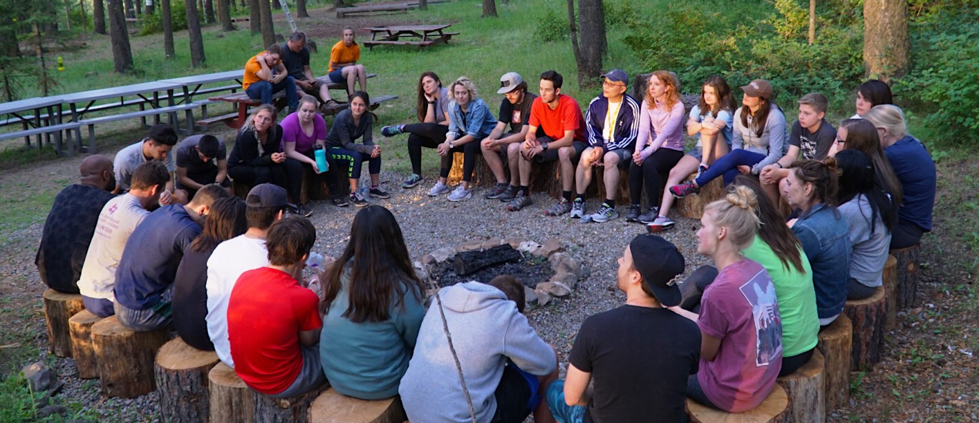 Students sit around a fire pit at a successful stuttering management workshop