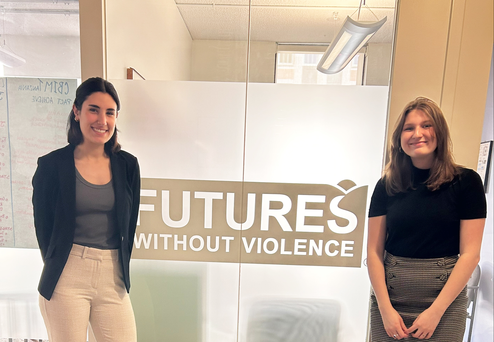 Two girls standing in front of a sign that says Futures Without Violence