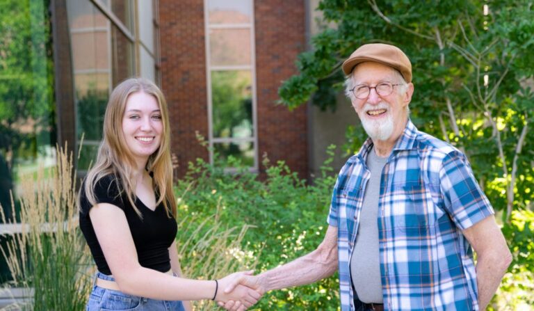 Erin Toulou, a junior, thanks longtime EWU Professor Bill Youngs for the award in support of her environmental research.