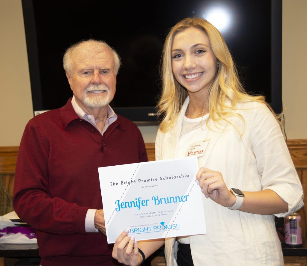 Jenny Brunner and Jim DeWalt holding a certificate and smiling