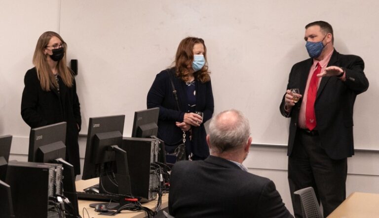 steiner speaking with colleagues