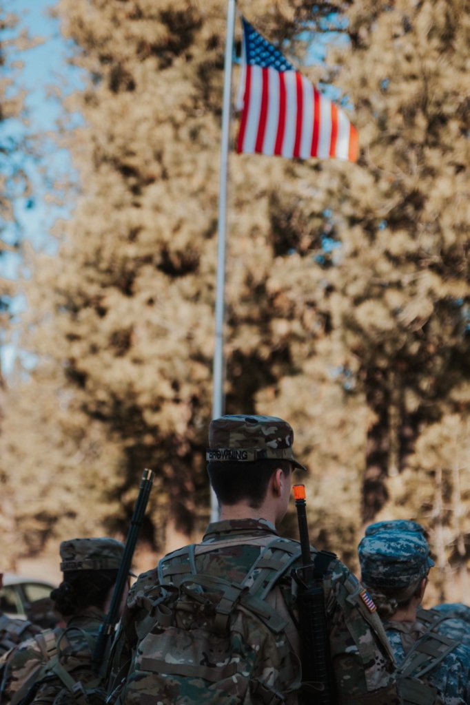 soldiers in uniform with American flag