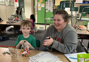 Jillian Headly gets some smiles from Finn, a first grader who is making good progress learning about vowels.