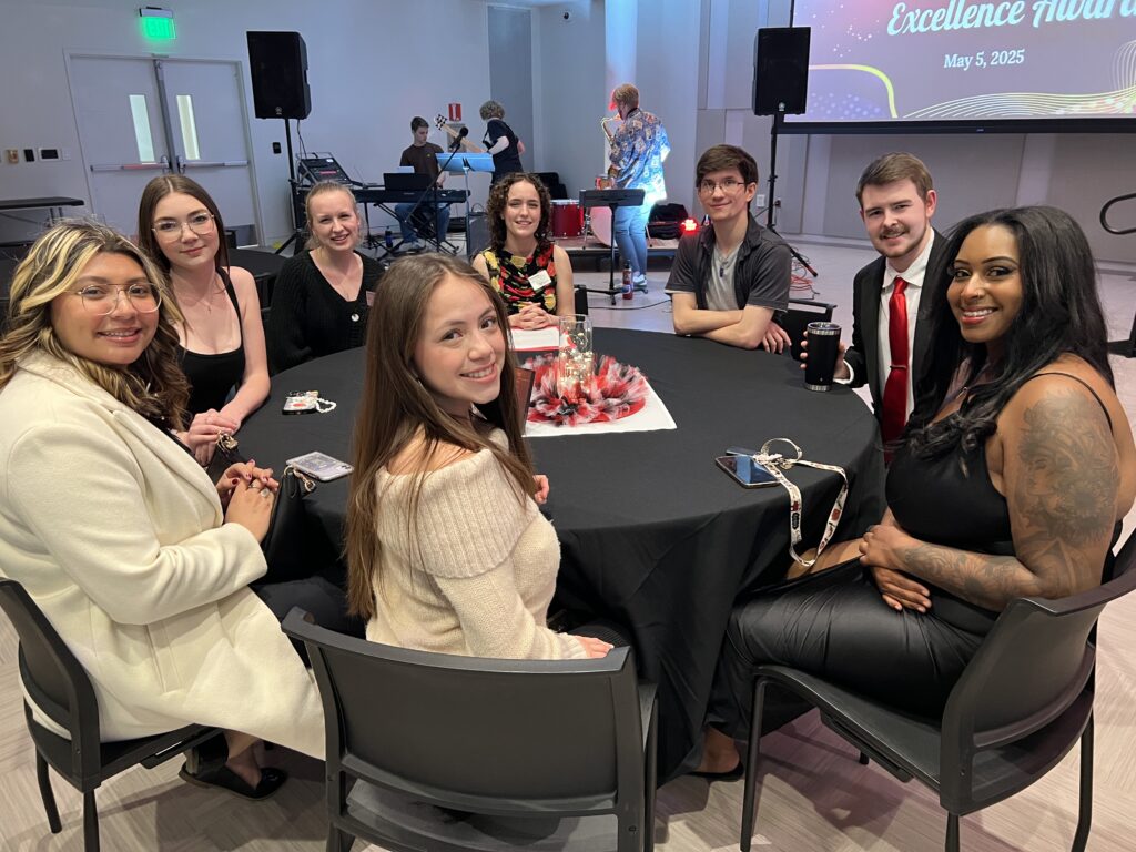 Table of students dressed in elegant attire.