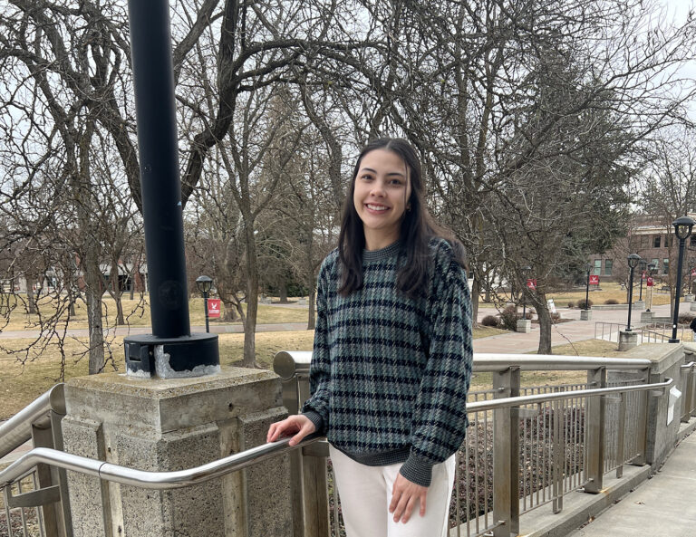 Photo of Eva, student scholarship recipient, outside of the JFK Library.