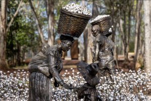 Statues of family of enslaved people doing the back-breaking work of harvesting cotton.
