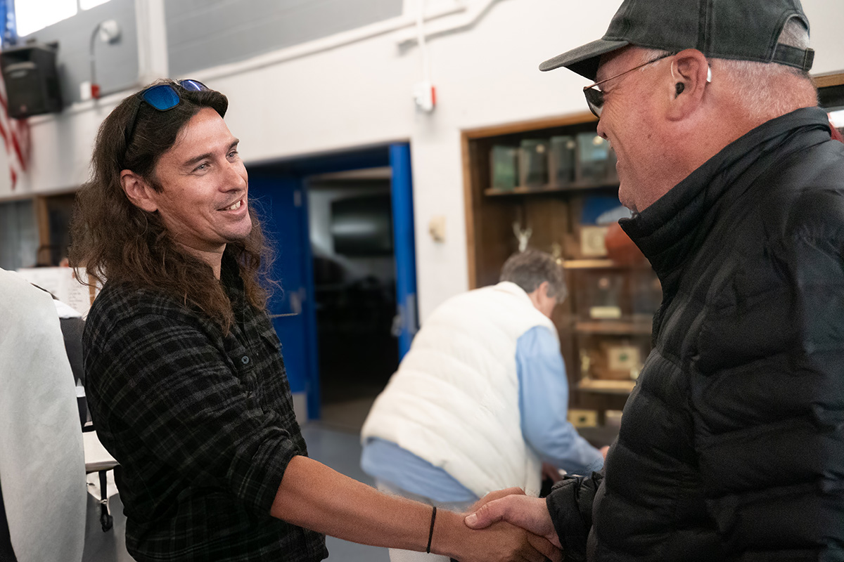 Photo of James Murphy shaking hands with Bill Sullivan at the reunion.
