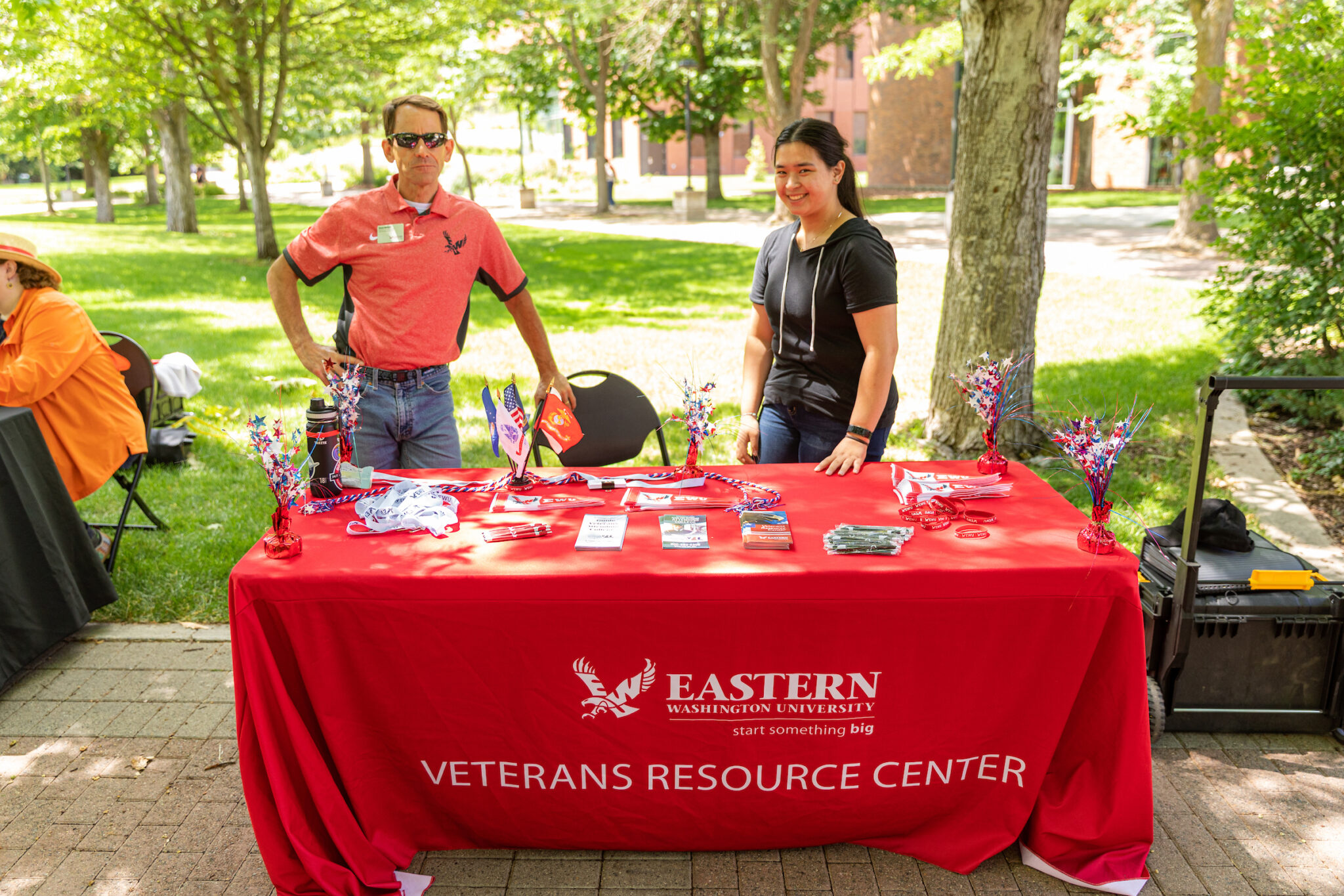 Dave Millet and another person man a table with VRC resources at a fair for new students.