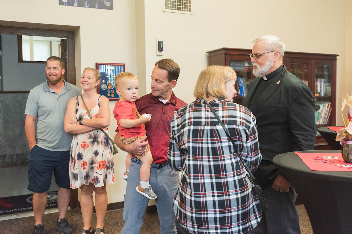 Dave pictured with his daughter and son holding his grandson