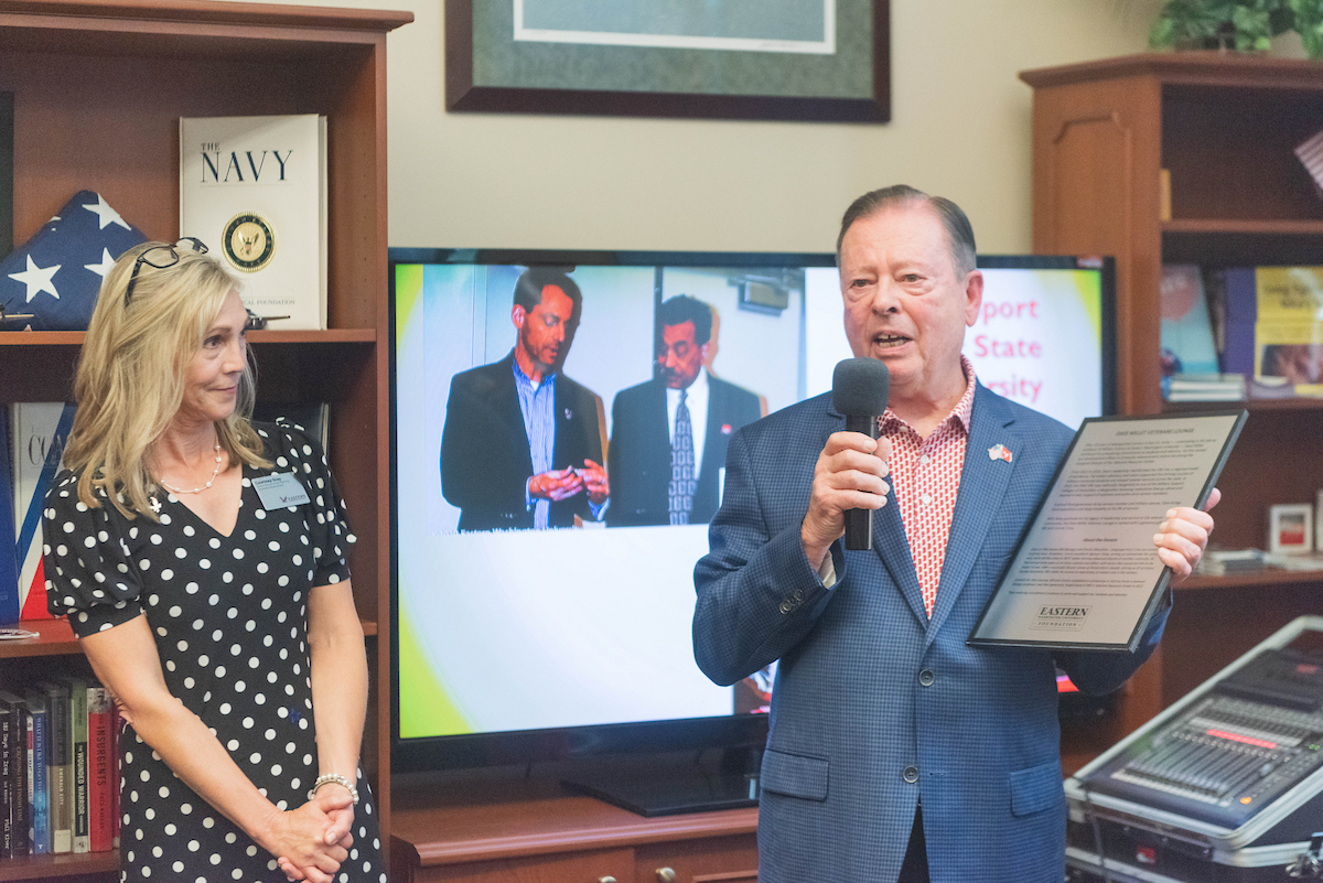 Bill Cross announcing the naming of the center and the scholarship with Courtney Gray of philanthropy in the background.