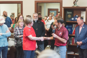 Dave Millet shakes hands with Lena Tanguay.
