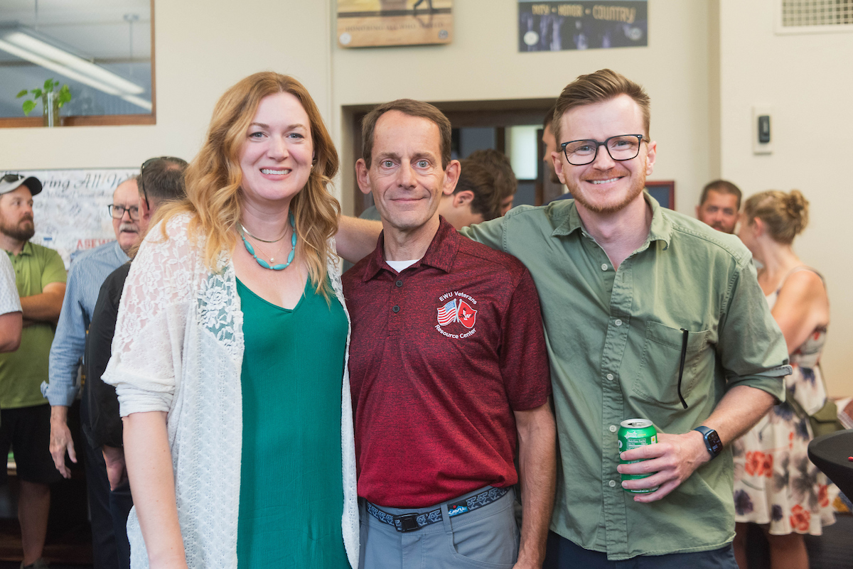 Dave posing with two employees he plays pickleball with, Ginny Baxter and Will Hall.