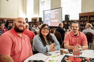 Photo of three employees smiling.