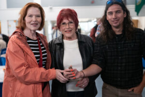 James Murphy, right, gives the found ring to Linda Wall-Sullivan, center, and Bink's daughter, Laura, on the left.