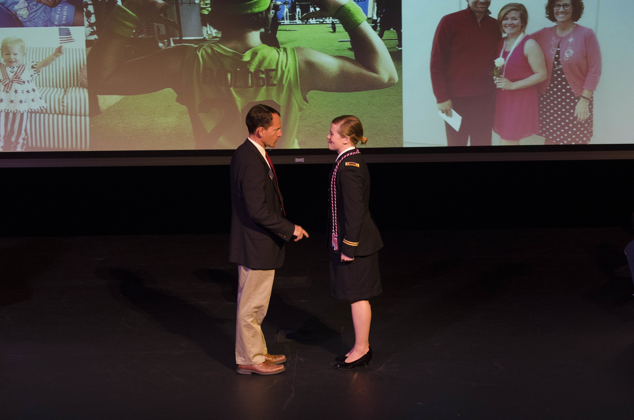 Millet on a stage presenting an award.