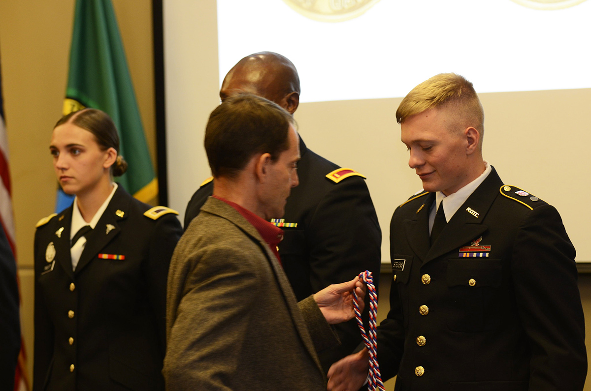 Dave Millet presents cadet with an award.
